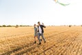 Happy young couple walking together at the wheat field Royalty Free Stock Photo