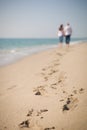 Happy young couple walking on a tropical beach. Lovers in full body length on beach. Back rear view. Honeymoon couple Royalty Free Stock Photo