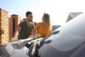 Happy young couple washing car at backyard Royalty Free Stock Photo