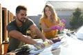 Happy young couple washing car at backyard