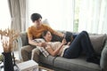 Happy young couple watching online media with a digital tablet having fun together in living room. Royalty Free Stock Photo