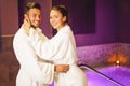 Happy young couple wearing bathrobe enjoying the spa day during their honeymoon - Romantic lovers having relax in a hotel spa Royalty Free Stock Photo