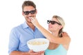 Happy young couple wearing 3d glasses eating popcorn Royalty Free Stock Photo