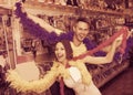 Happy young couple wearing feather boa