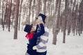 Happy Young Couple in Winter Park having fun. Family Dressed in funny hats cylinders Royalty Free Stock Photo