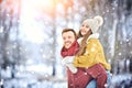 Happy Young Couple in Winter Park laughing and having fun. Family Outdoors. Royalty Free Stock Photo