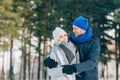 Happy Young Couple in Winter Park laughing and having fun. Family Outdoors.