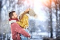 Happy Young Couple in Winter Park laughing and having fun. Family Outdoors.