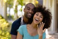 Happy young couple with woman showing her wedding ring