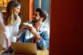 Happy young couple working studying on laptop and digital devices. Business education people concept Royalty Free Stock Photo