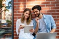 Happy young couple working studying on laptop and digital devices. Business education people concept Royalty Free Stock Photo