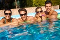 Happy young couples in pool Royalty Free Stock Photo