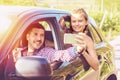 Happy young couples on road trip taking selfie while driving on countryside road Royalty Free Stock Photo