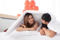 Happy young couples are talking to each other on a bed. Royalty Free Stock Photo