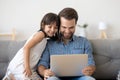 Happy dad relax watching cartoons with little daughter Royalty Free Stock Photo