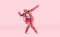 Happy funny male dancer in pink suit, trainers and glasses dancing in the studio Royalty Free Stock Photo