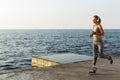 Happy young disabled woman with prosthetic leg running