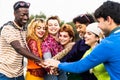 Happy young diverse friends having fun stacking hands together outdoor Royalty Free Stock Photo