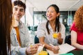 Happy young diverse group of students sitting together at campus college. Royalty Free Stock Photo