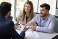 Happy young diverse husband and wife consulting legal adviser Royalty Free Stock Photo