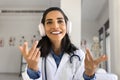 Happy young doctor woman using wireless head phones