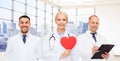 Happy young doctors cardiologists with red heart Royalty Free Stock Photo