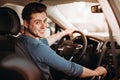 Happy young driver behind the wheel of a car. Buying a car and driving concept. Royalty Free Stock Photo