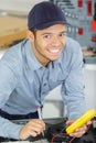 happy young electrician at work measures Royalty Free Stock Photo