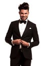 Happy young elegant man in tuxedo buttoning his coat Royalty Free Stock Photo