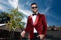 Happy young elegant man walking in red velvet tuxedo Royalty Free Stock Photo