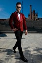 Happy young elegant man walkinga and wearing red velvet tuxedo Royalty Free Stock Photo