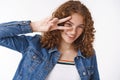 Happy young energized redhead girl with curly hair pimples forehead freckled tilting head joyfully smiling camera Royalty Free Stock Photo