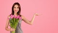 Happy young european woman in dress enjoy bouquet of flowers, tulips Royalty Free Stock Photo