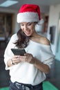 Happy young excited woman online shopping for Christmas on tablet at home Royalty Free Stock Photo