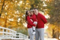 Happy young family in the autumn park. People having fun in nature. Family bonds outside. Mother, father and child smiling while Royalty Free Stock Photo