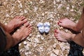 Happy young family awaiting baby, love and happiness. Future mom and dad feet with little unborn baby shoes, closeup.