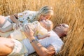 Family with baby lying and resting among wheat field Royalty Free Stock Photo