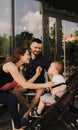 Happy young family with baby son eating lunch together at restaurant and having fun. Soft focus blurred and noise effect Royalty Free Stock Photo