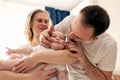 Happy young family. Beautiful mother and father kiss and hug their baby. Parents, Portrait of mom, dad and smiling child Royalty Free Stock Photo