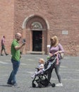 Happy young family with a child, taking selfie at city square