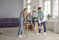 Happy young family with children having fun while moving to a new house or apartment Royalty Free Stock Photo