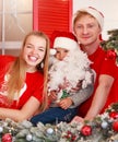 Happy young family with children joyfully celebrate new year together at house on veranda, in Christmas decorations