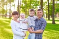 Happy young family with children walks in the summer park Royalty Free Stock Photo