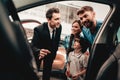 Young Family Are Choosing A New Car In Showroom. Royalty Free Stock Photo