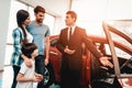 Young Family Are Choosing A New Car In Showroom. Royalty Free Stock Photo