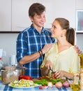 Couple cooking vegetables at kitchen. Royalty Free Stock Photo