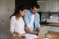Happy young family couple calculating domestic expenditures. Royalty Free Stock Photo