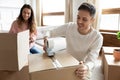 Happy young family couple renters packing on moving day together Royalty Free Stock Photo