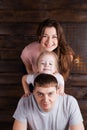 Happy young family with cute kid making funny shots. Togetherness, love, .family values