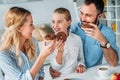 happy young family eating chocolate